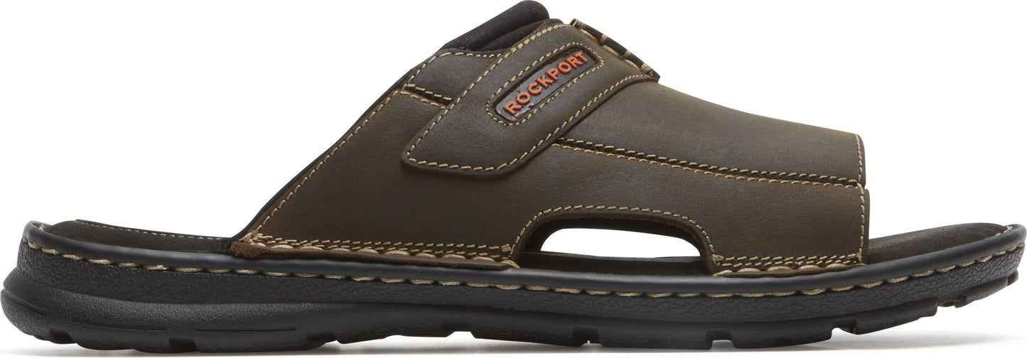 A brown leather sandal with a black sole.