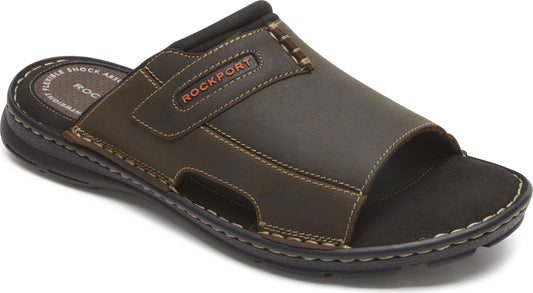 Brown leather slide sandal with black sole and the word ROCKPORT.