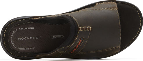 A top-down view of a brown sandal with visible stitching and the word 'ROCKPORT' on the side.