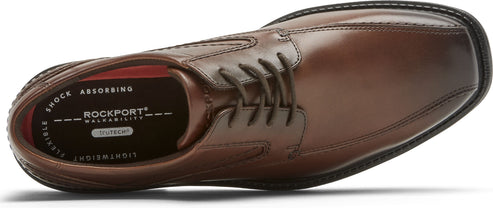 A brown leather dress shoe with laces.