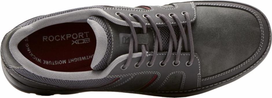 A gray shoe with laces, featuring a gray interior lining with the text ROCKPORT XCS visible.