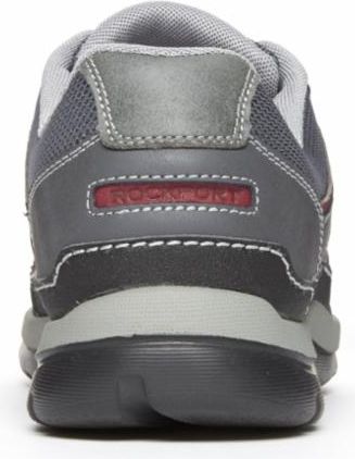 Back view of a gray and black athletic shoe with a gray mesh collar, a dark gray heel cup, a gray midsole, and a black outsole. The heel cup has a rectangular red patch with white text.