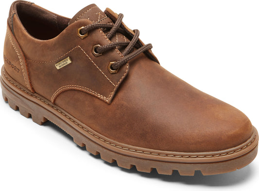 Brown leather lace-up shoe with lug sole and visible stitching.