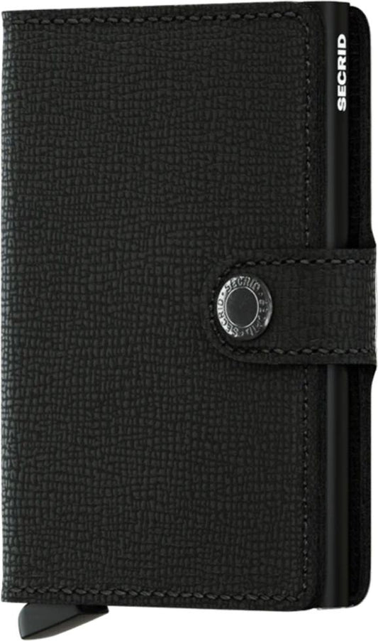 Small textured black card holder with button closure and a card slider.