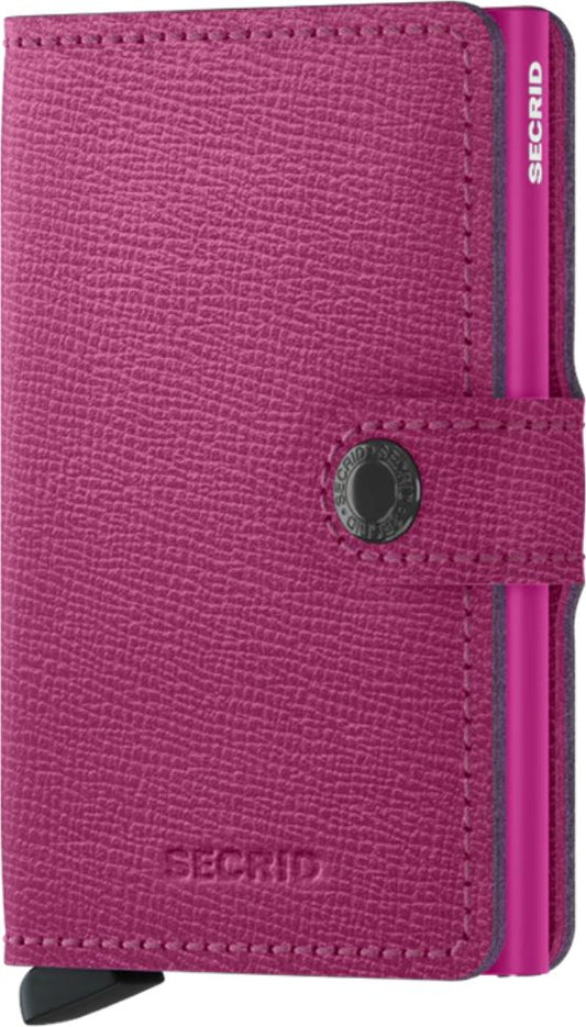 Pink leather wallet with a metal card slider, button closure, and SECRID text.