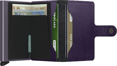 Open purple wallet with a button closure, a silver card protector displaying euro notes, and card slots containing credit cards.