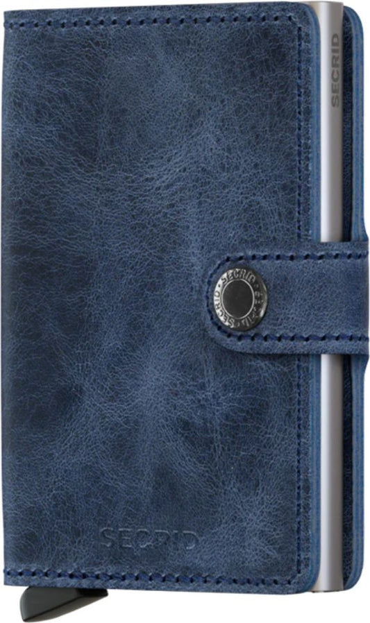 Blue leather card holder with metal case secured by a strap with metal button.
