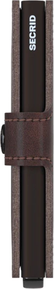 A thin, dark brown wallet with SECRID printed on the side and a brown leather band around it.