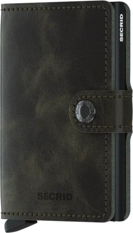 Closed small dark green leather wallet with a slider and snap button.