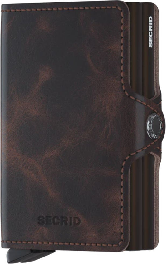 Brown leather wallet with metal card holder and button closure.