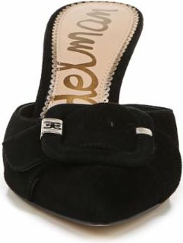 Close up of a black, suede mule with a decorative buckle.