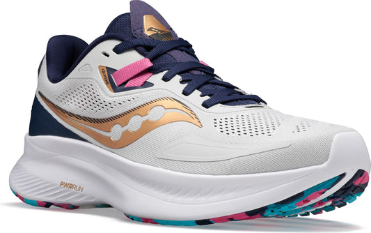 A white running shoe with a bronze logo, navy blue laces and accents, and a pink detail.