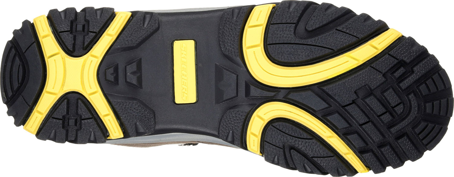 The bottom of a shoe is black with yellow accents, showing a tread pattern.