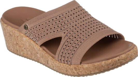 Wedge sandal with taupe knit upper, decorative perforations, cork wedge, and slide-on style.