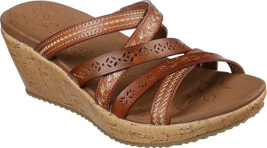Tan wedge sandals with decorative tan straps.