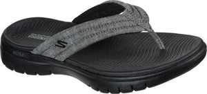 A gray flip-flop with a fabric strap and a black sole.