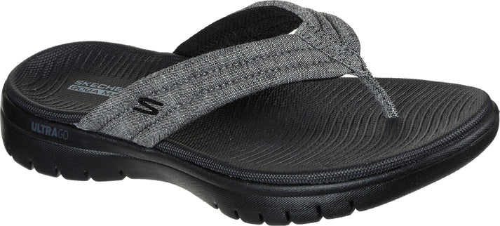 A gray flip-flop with a fabric strap and a black sole.