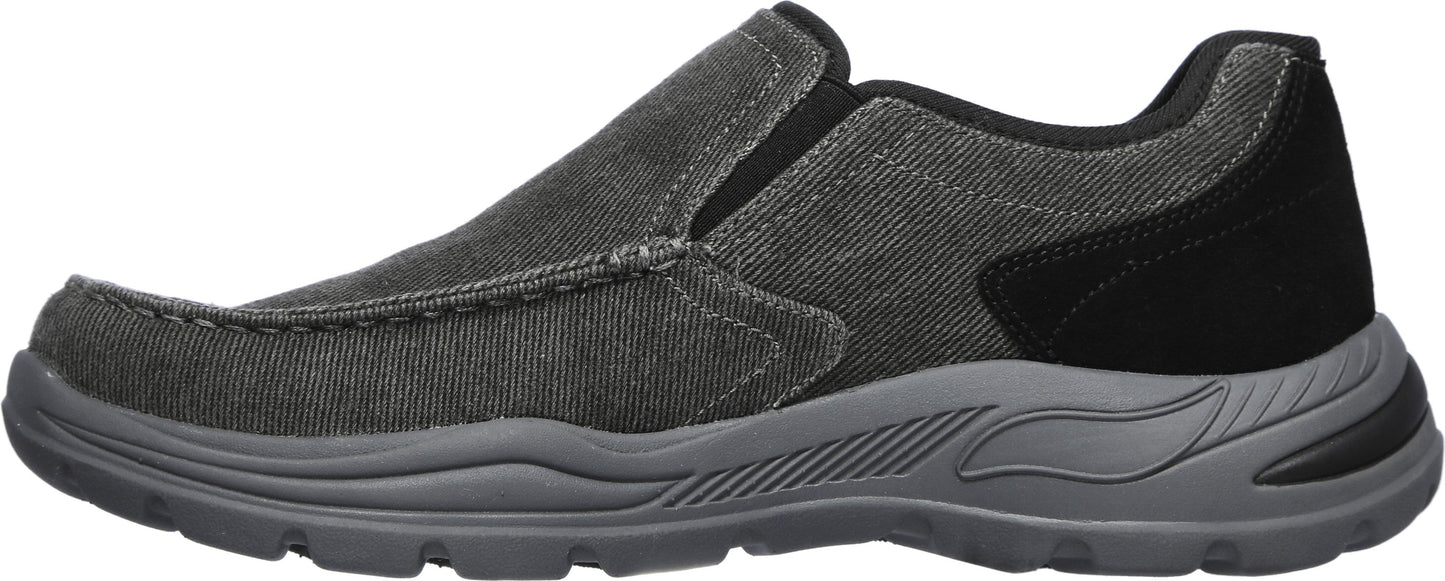 A slip-on, low profile shoe in gray with a black heel.