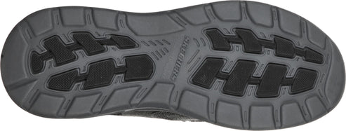 A shoe sole in gray with a pattern of black rectangular treads.