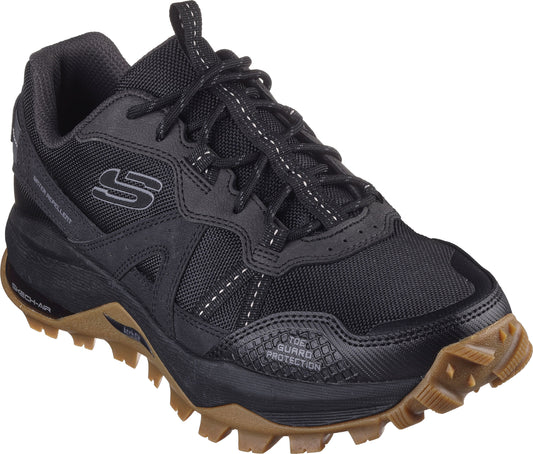 A black hiking shoe with brown rubber soles.