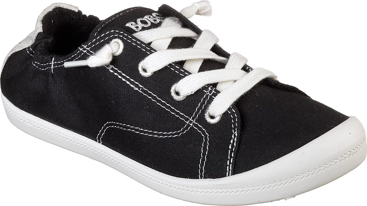 Black slip-on sneaker with white laces and white sole.