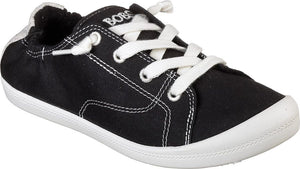 Black slip-on sneaker with white laces and white sole.