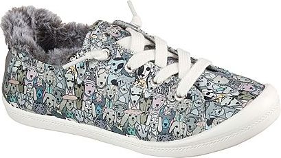 Slip-on sneaker covered in cartoon dog faces, with white laces and a furry collar.