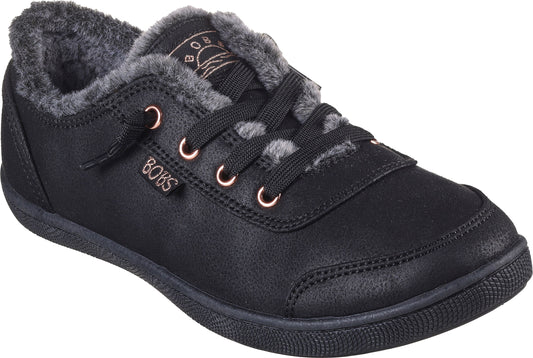 A low-top black sneaker with faux fur lining, metal eyelets and dark laces.