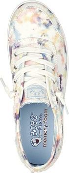 A top-down view of a pair of canvas lace-up sneakers with a tie-dye pattern. The insole is visible and has the words "BOBS" and "memory foam" printed on it.