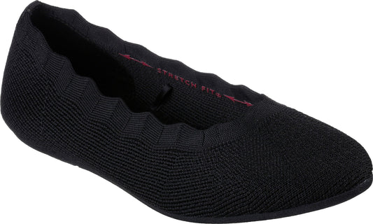 Black knit slip-on flat shoe with scalloped edges.