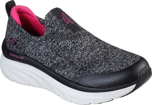 Slip-on sneaker with a black and white knit upper, pink interior, a thick white sole, and a black rubber toe cap.