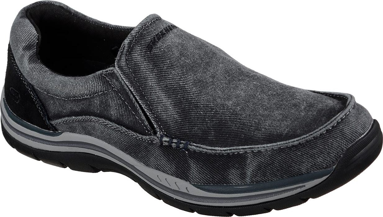 Slip-on sneaker with grey canvas upper and black sole.