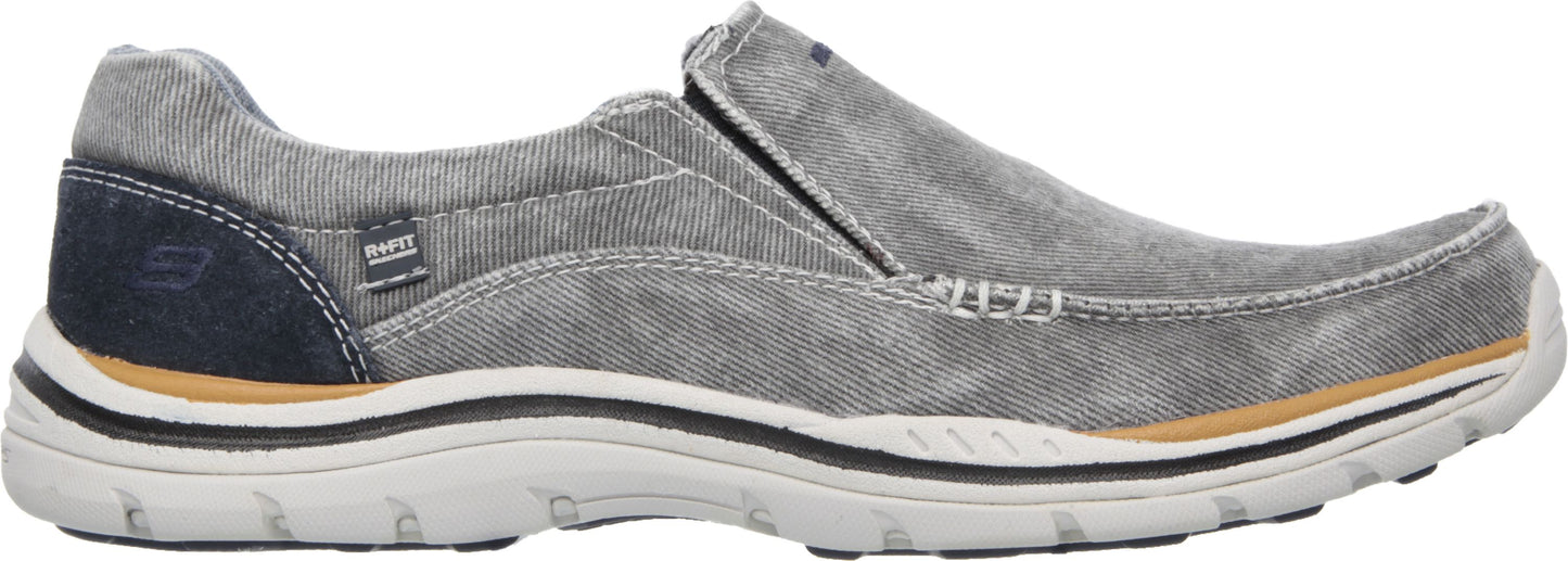A grey slip-on shoe with a white sole.