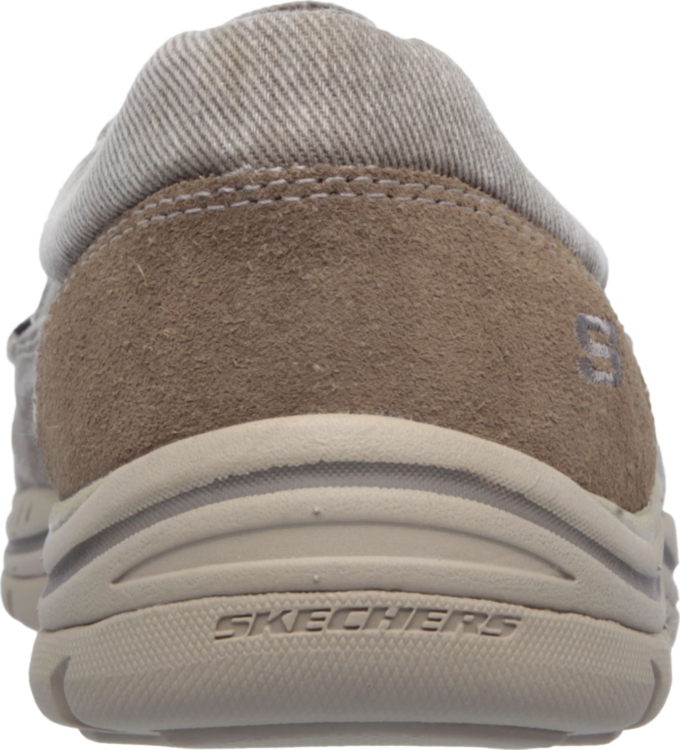 Back view of casual shoe with mixed material upper and prominent textured sole, labeled 'SKECHERS'.