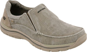 Beige canvas slip-on shoe with visible stitching and the word 'SKECHERS' on the tongue.
