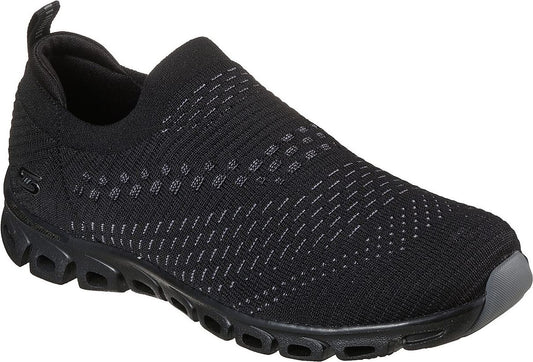 A black slip-on sneaker with a textured upper and a segmented black sole.