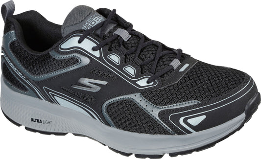 A black mesh sneaker with a gray sole and silver accents.