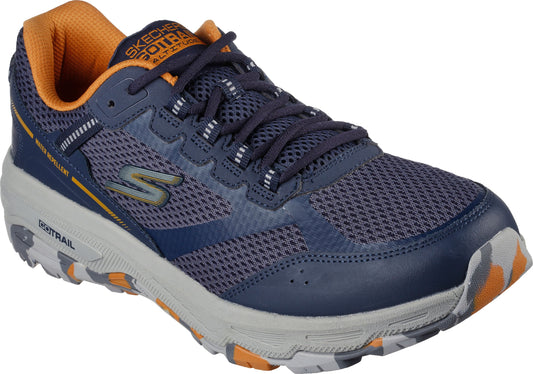 A low-top trail running shoe, navy with orange trim, lace up, rugged sole, and side "G" logo.