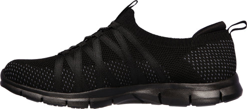 A black slip-on sneaker with a mesh upper and black sole.