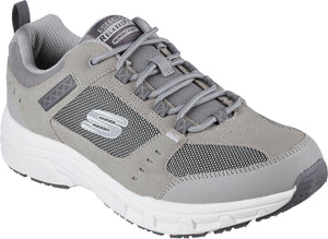 A gray sneaker with a white sole, gray laces, mesh accents, and the letter S on the side. The words "RELAXED FIT" and "MEMORY FOAM" are on the tongue.