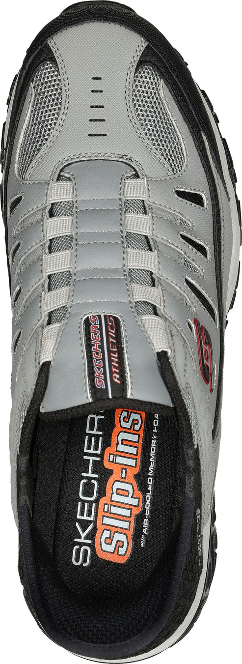 Overhead view of a gray sneaker with black trim and a gray mesh toe. "SKECHERS Slip-ins" text is inside the shoe.