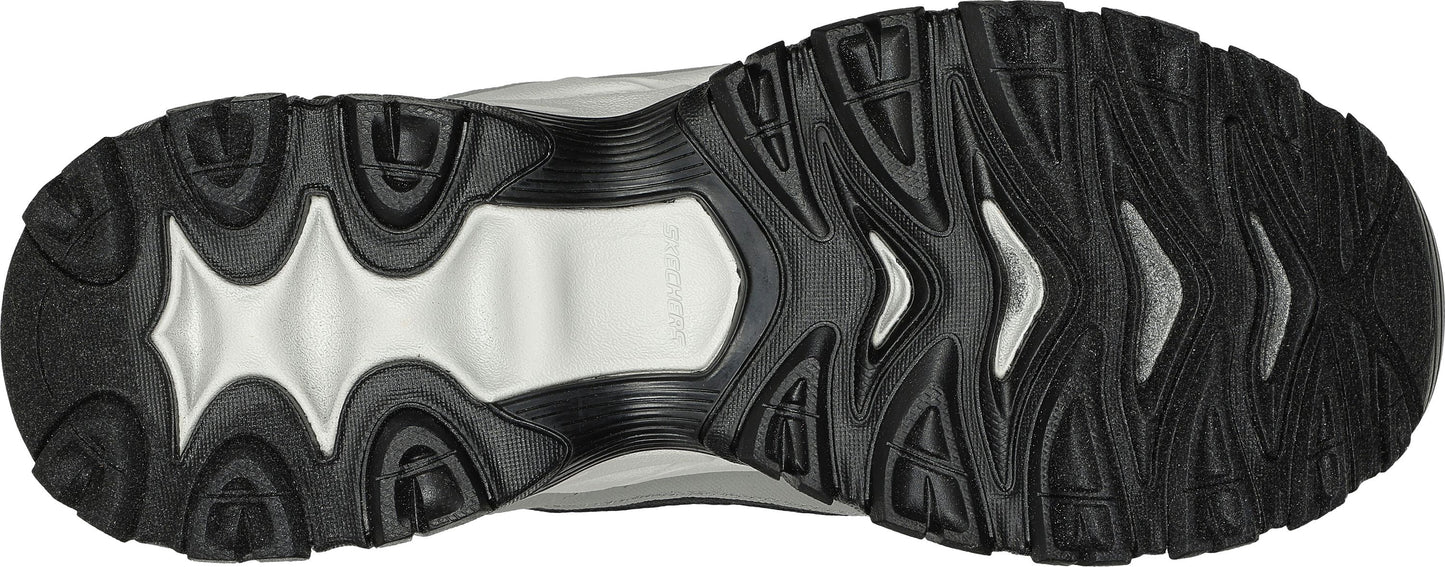 Bottom view of a shoe sole with a black tread and white insets.