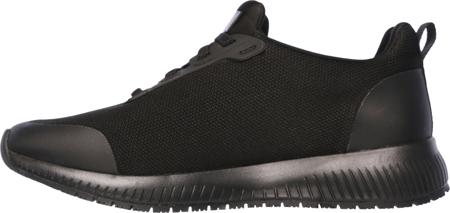 A black sneaker with a low profile and a black sole.