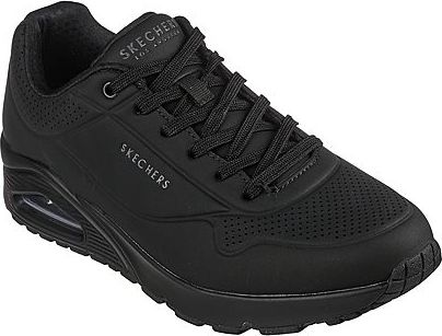 Black sneaker with laces and raised platform sole, and "SKECHERS" visible on the side.