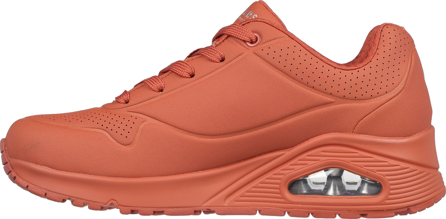 A sneaker with a lace-up closure and a thick, cushioned sole.