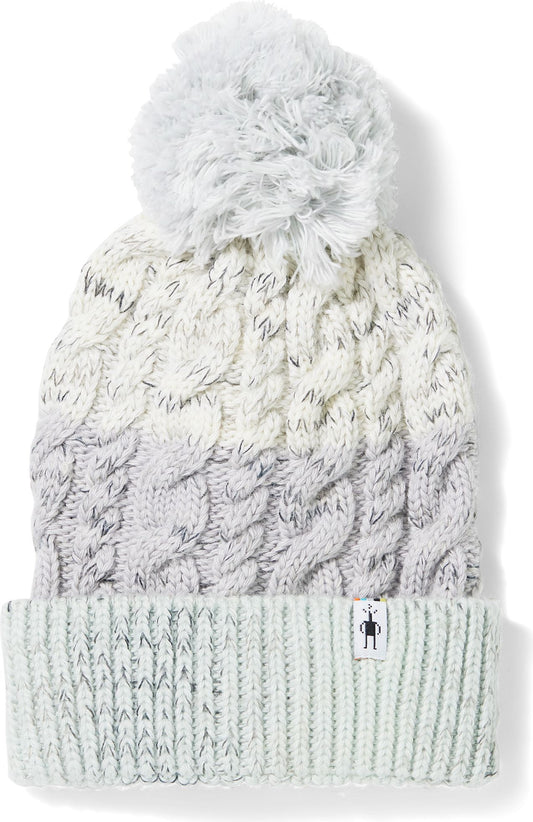 Cable knit hat with a pompom on top, ombre style.