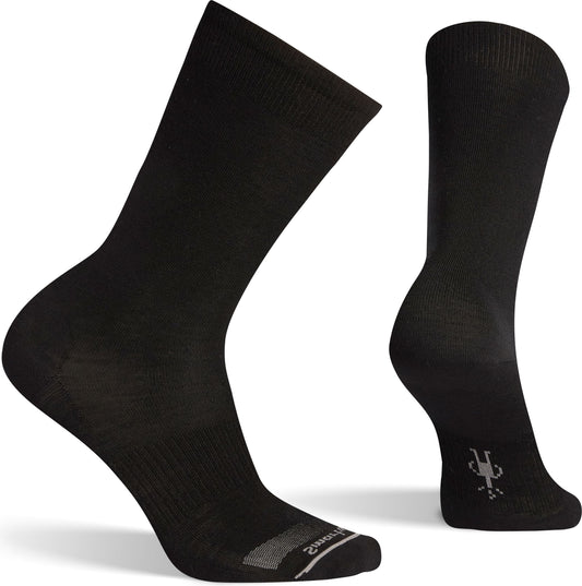 A pair of black crew socks with a gray logo on the heel.