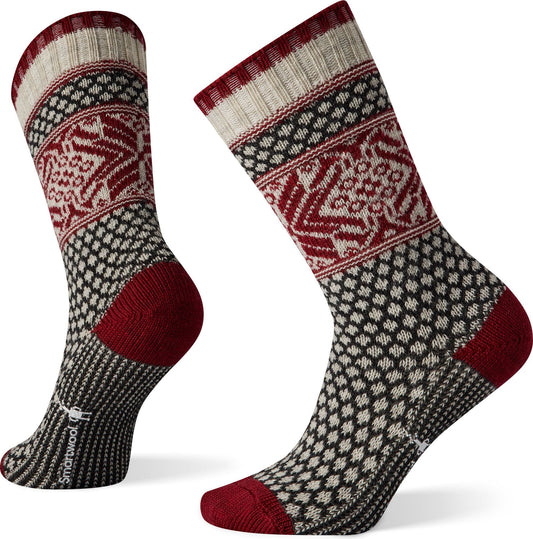 Two socks with cream and red snowflake-like patterns, red heels and toes, and black and cream dot pattern.