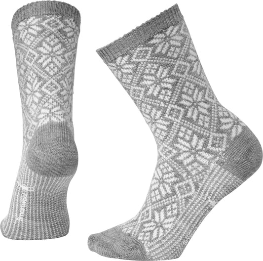 Two gray socks with white geometric snowflake designs.