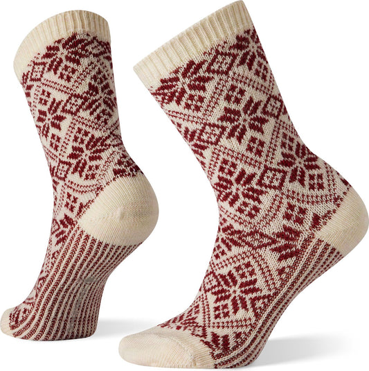 Two cream-colored socks with a red Nordic snowflake pattern.
